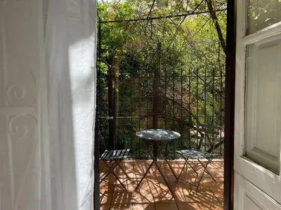 a view of a patio with a table and a window at The Tangerine's Garden in Palermo