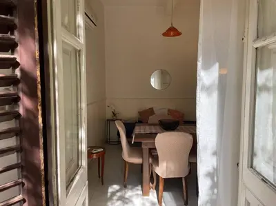 a dining room with a table and some chairs at The Tangerine's Garden in Palermo
