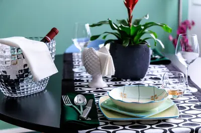 a black table with a black and white table cloth with a plate at Merlo5 in Palermo
