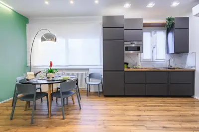 a kitchen and dining room with a table and chairs at Merlo5 in Palermo