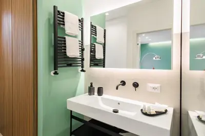 a bathroom with a white sink and a mirror at Merlo5 in Palermo