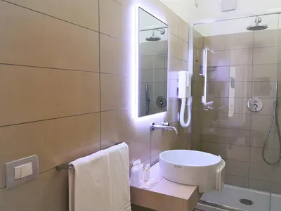a bathroom with a shower and a sink and a toilet at Hotel Perla Gaia in San Vito lo Capo