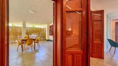 a door leading to a dining room with a table and chairs at Villa Sao Scopello Punta Pispisa in Scopello