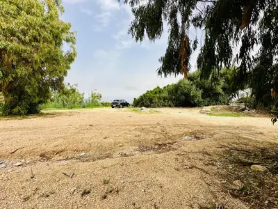 a dirt road with a car parked in the distance at Villa Sao Scopello Punta Pispisa in Scopello
