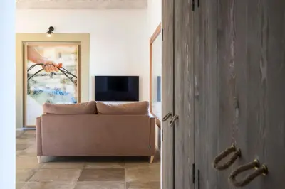a living room with a couch and a television at Villa Mori Cala Bianca in Castellammare del Golfo