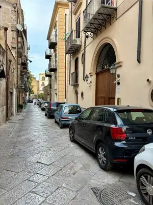 a row of cars parked on the side of a street at Daniel's Winter in Palermo