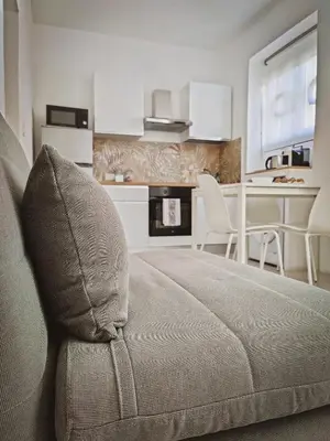 a living room with a bed and a dining room at Casa Nicuzza alla Zisa in Palermo