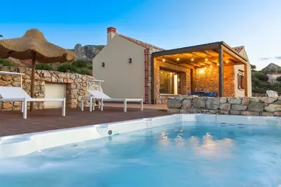 a swimming pool in front of a house at Villa Disa Cala Bianca in Castellammare del Golfo