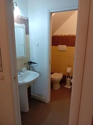 a bathroom with a sink and a toilet at Papireto house in Palermo