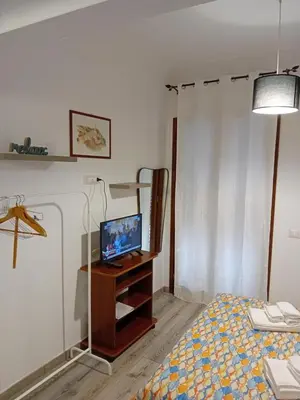 a bedroom with a bed and a television on a table at Accademia in Palermo