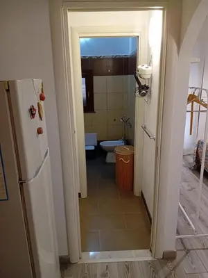 a kitchen with a refrigerator and a bathroom with a toilet at Accademia in Palermo