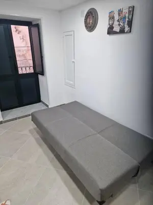 a bed in a room next to a door at Rosselli house 5 in Palermo