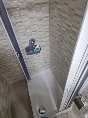 a shower with a shower head in a bathroom at Rosselli house 5 in Palermo