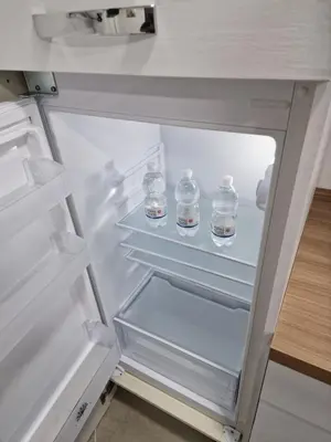an open refrigerator with bottles of water in it at Rosselli house 5 in Palermo