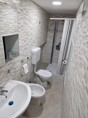 a bathroom with a toilet and a sink and a shower at Rosselli house 5 in Palermo