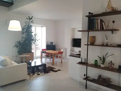 a living room with a couch and a table at Loft in Vucciria in Palermo