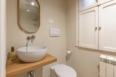 a bathroom with a bowl sink and a toilet at La casa nel baglio in Palermo