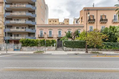 an empty street in front of a building at La casa nel baglio in Palermo