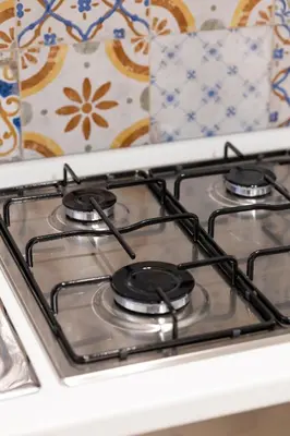 a stove top with three burners on top of it at Giancos apartment in Palermo