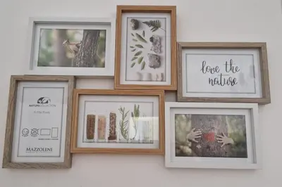 a group of framed pictures on a wall at Casa Maielli in Palermo