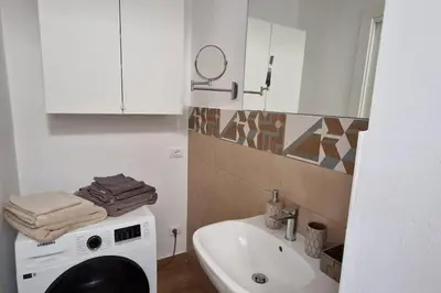 a bathroom with a washing machine and a sink at Casa Maielli in Palermo