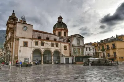 a large building with a clock tower on top of it at L'ùoro Apartment in Carini