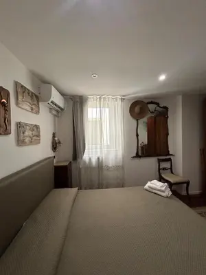 a bedroom with a large bed and a window at Appartamento Palermo Sole di Sicilia in Palermo