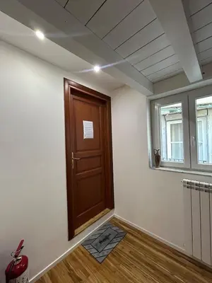 a room with a wooden door and a window at Appartamento Palermo Sole di Sicilia in Palermo