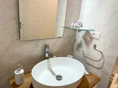 a bathroom with a white sink and a mirror at La Casetta di Ale - By Rental BeB Italy - in Palermo