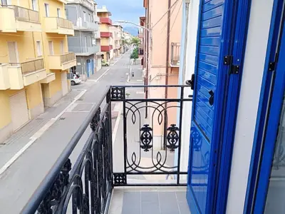 a view of a balcony with a blue door at Casa Agatea in Balestrate