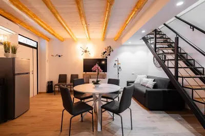 a living room with a table and a couch at Maqueda Luxury Suite & Home in Palermo