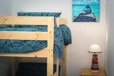 a bunk bed in a room with a lamp at Residence Spiaggia Centro - Aria Condizionata Wi-Fi&SelfCheck-In - Sole&Mare Home in Balestrate