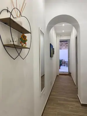 a hallway with a heart shaped mirror on the wall at Myrica House in Palermo