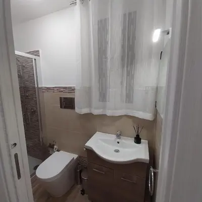 a bathroom with a white sink and a toilet at Myrica House in Palermo