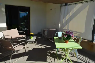 a patio with chairs and tables with flowers on it at Casa Paola in Monreale