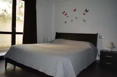 a bedroom with a bed with butterflies on the wall at Casa Paola in Monreale
