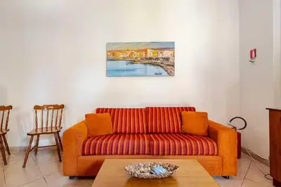 a living room with a couch and a table at Villa Marinella by Sicily Travelling Villas in Scopello