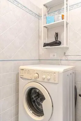 a washer and dryer in a small bathroom at Villa Uzzo by Sicily Travelling Villas in Scopello