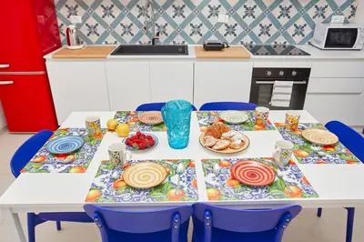 a table with plates of food on it in a kitchen at Le Residenze di Zio Toto' in Scopello