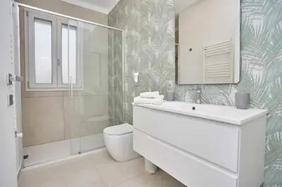 a bathroom with a sink and a toilet and a shower at Le Residenze di Zio Toto' in Scopello