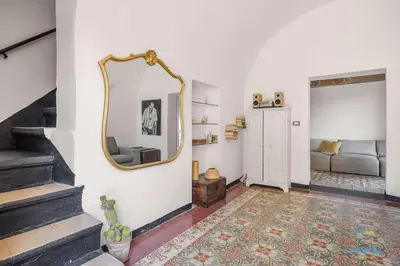 a living room with a mirror and a couch at Verosicily Villa Damus in Terrasini