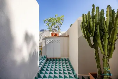 a cactus sitting on the side of a building with a tile floor at Verosicily Villa Damus in Terrasini