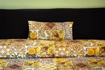 a bed with pillows on top of it at Le Meraviglie della Sicilia in Palermo