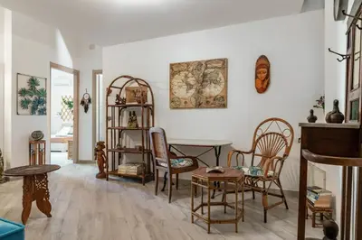 a living room with a table and chairs at GuestHost - The Flavour of Palermo - Kalsa Lovely Apartment in Palermo