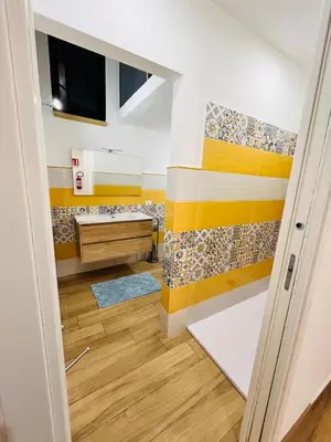 a small bathroom with a sink and a tv at Casa Vacanze di Maria in Palermo