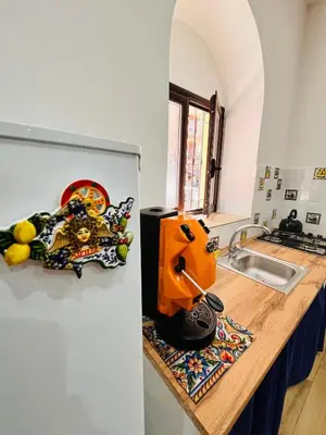 a kitchen counter with an orange juicer sitting on it at Casa Vacanze di Maria in Palermo