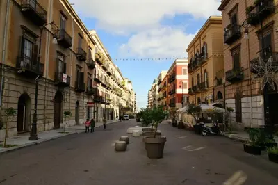 an empty street in a city with buildings at Mansarda di Gabriella al Politeama - City center in Palermo