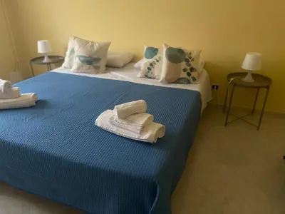a bedroom with two beds with towels on them at Sicily Holiday Home in Termini Imerese