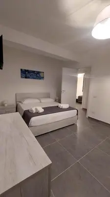 a bedroom with a large bed in a room at Casa Vacanza Ciglietti in San Vito lo Capo