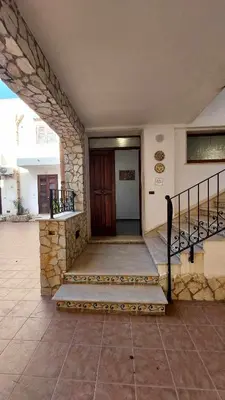 a entrance to a building with stairs and a door at Casa Vacanza Ciglietti in San Vito lo Capo